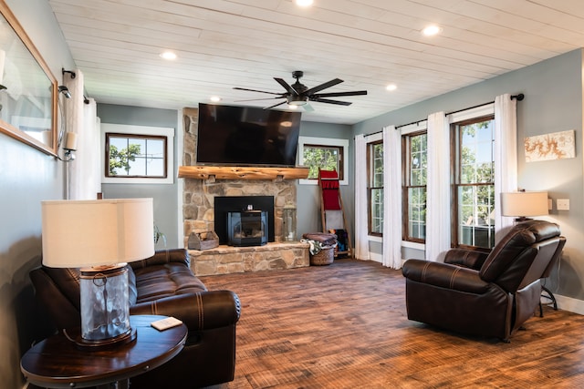 living room featuring wood-type flooring, a stone fireplace, wood ceiling, and ceiling fan