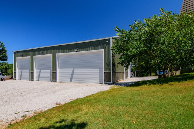 garage featuring a lawn