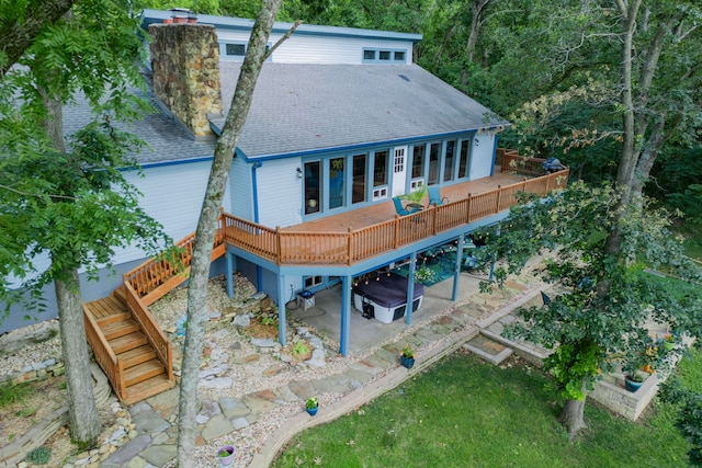 back of property featuring a wooden deck and a patio area