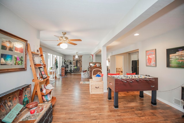 playroom with ceiling fan and light hardwood / wood-style flooring