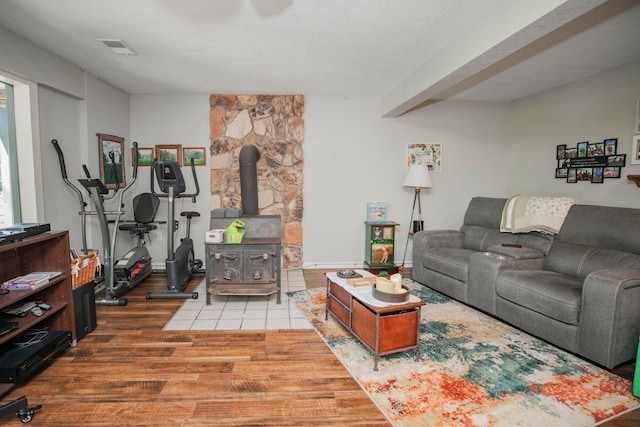 living room featuring a wood stove and hardwood / wood-style floors