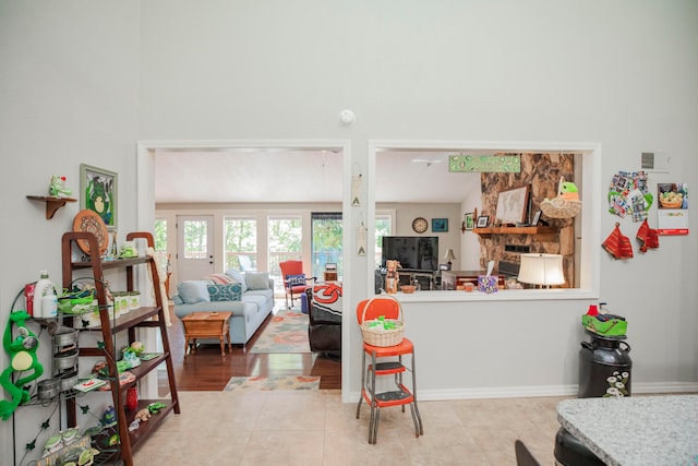 living room with lofted ceiling and light tile patterned floors