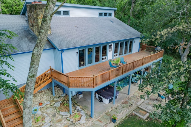 rear view of property featuring a deck and a patio area