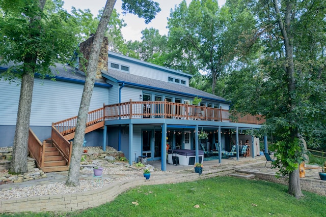 rear view of house featuring a wooden deck