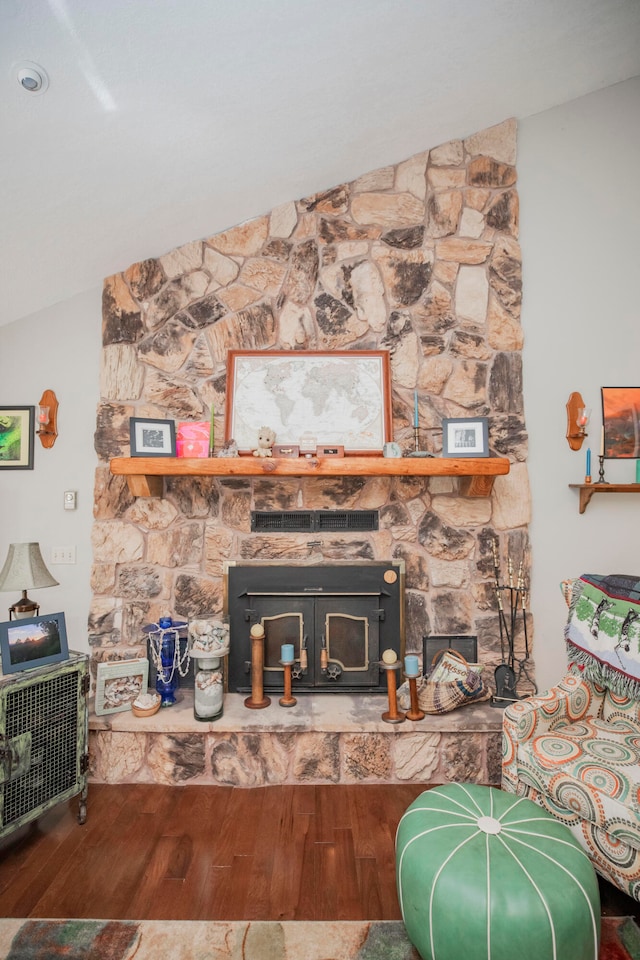 living room with lofted ceiling, a fireplace, and hardwood / wood-style floors