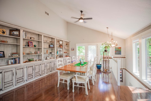 dining space featuring ceiling fan with notable chandelier, dark hardwood / wood-style flooring, and high vaulted ceiling