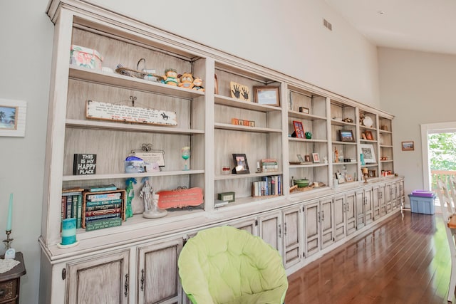 living area featuring lofted ceiling and dark hardwood / wood-style floors