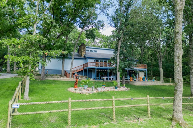 back of house with a wooden deck and a yard