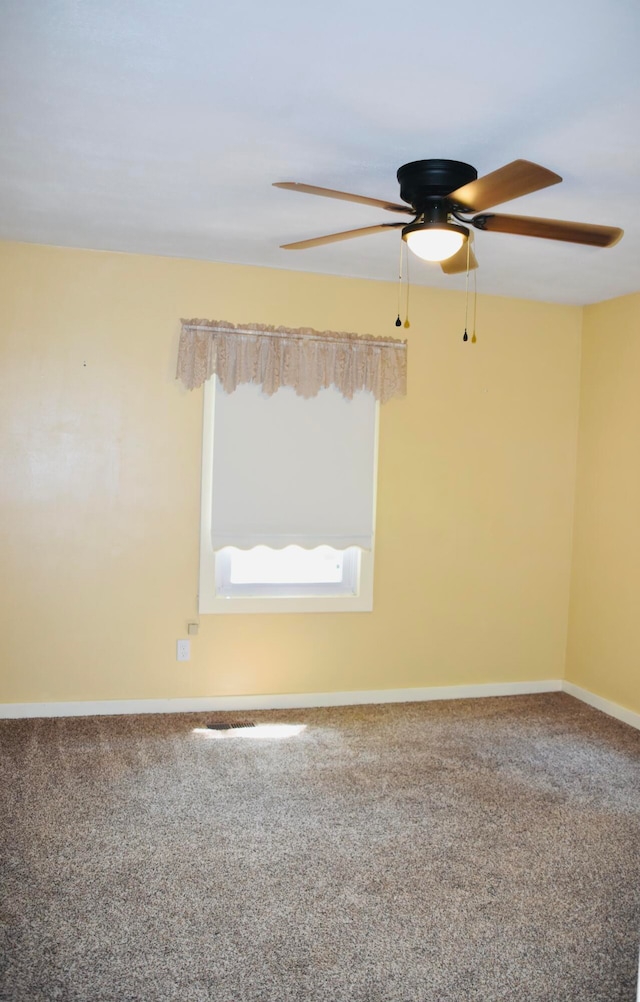 spare room featuring carpet floors and ceiling fan