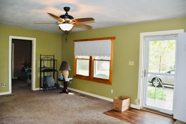 interior space with carpet flooring and ceiling fan