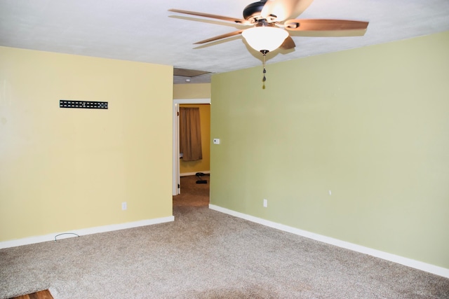 unfurnished room featuring ceiling fan and carpet