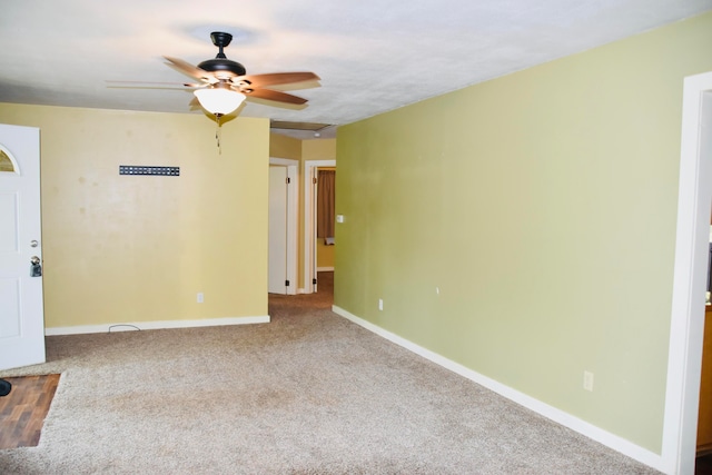 carpeted empty room featuring ceiling fan