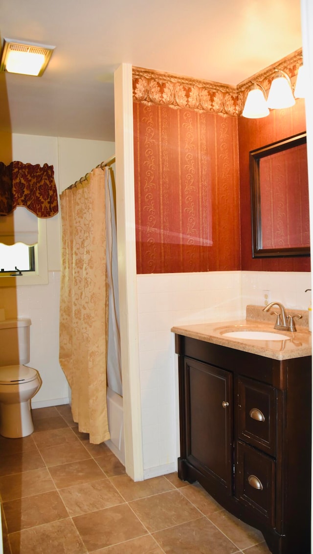 full bathroom featuring toilet, vanity, and shower / bath combination with curtain