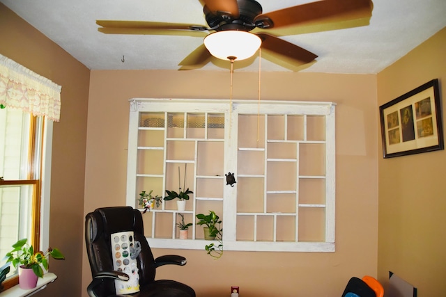 sitting room featuring ceiling fan