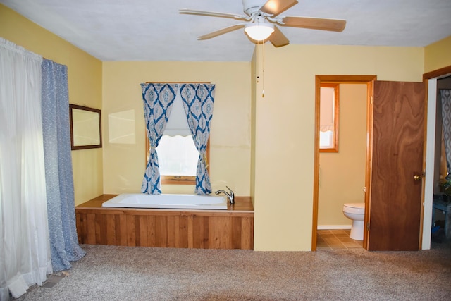 unfurnished bedroom featuring carpet flooring, ceiling fan, and connected bathroom