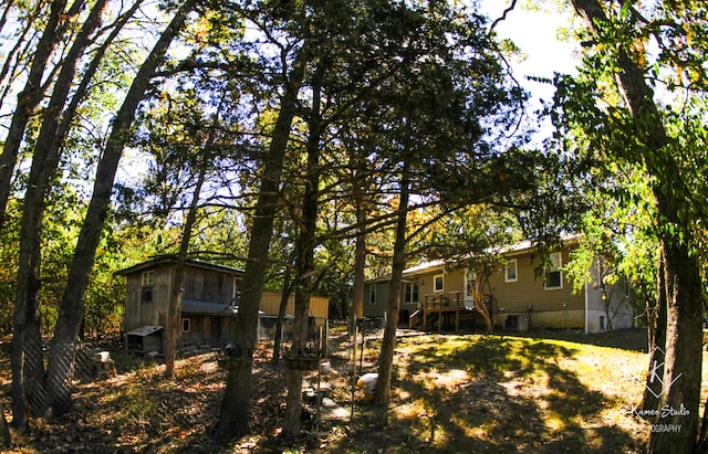 rear view of property with a wooden deck