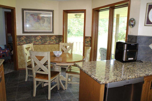 dining space with dark tile patterned flooring