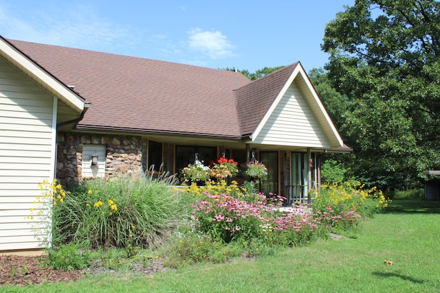 view of side of home with a yard