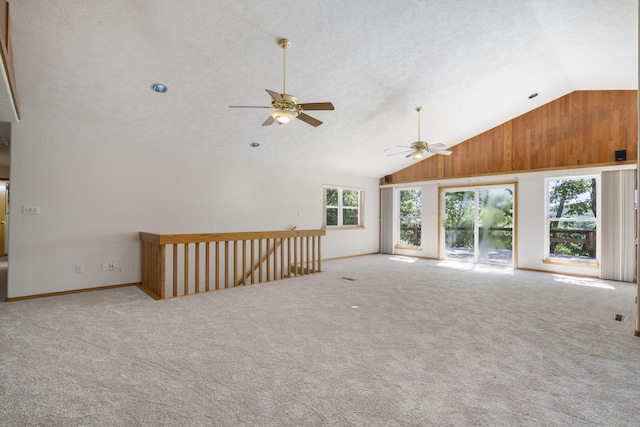 carpeted spare room featuring ceiling fan, a textured ceiling, and high vaulted ceiling