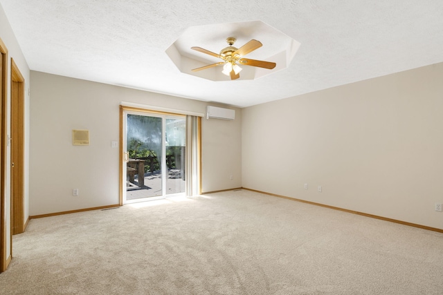 unfurnished room with light carpet, a wall unit AC, ceiling fan, and a textured ceiling