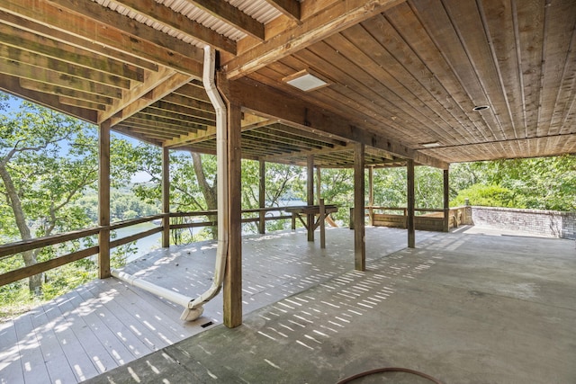 view of patio featuring a deck with water view