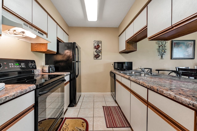 kitchen with light tile patterned floors, sink, white cabinetry, and black appliances