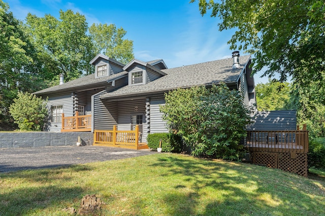 log cabin featuring a front yard and a wooden deck