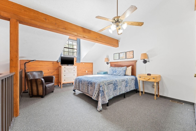 bedroom with ceiling fan, vaulted ceiling with beams, and carpet