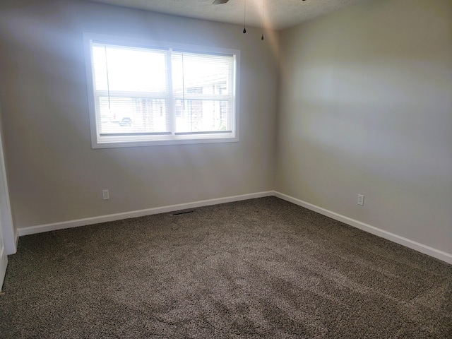 carpeted empty room featuring a textured ceiling and ceiling fan