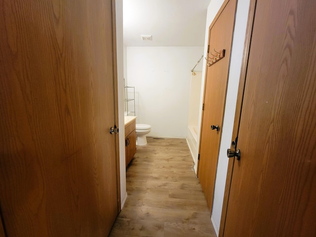 full bathroom with shower with separate bathtub, hardwood / wood-style floors, vanity, and toilet