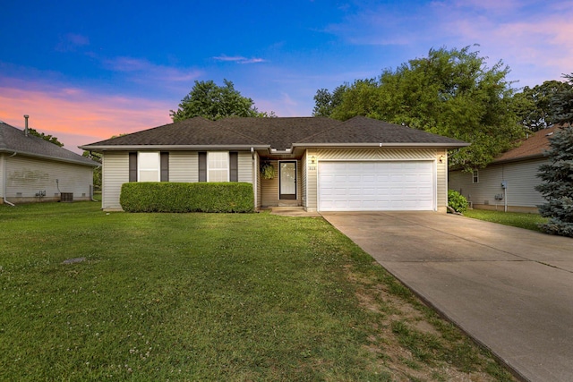 single story home featuring central AC unit, a lawn, and a garage