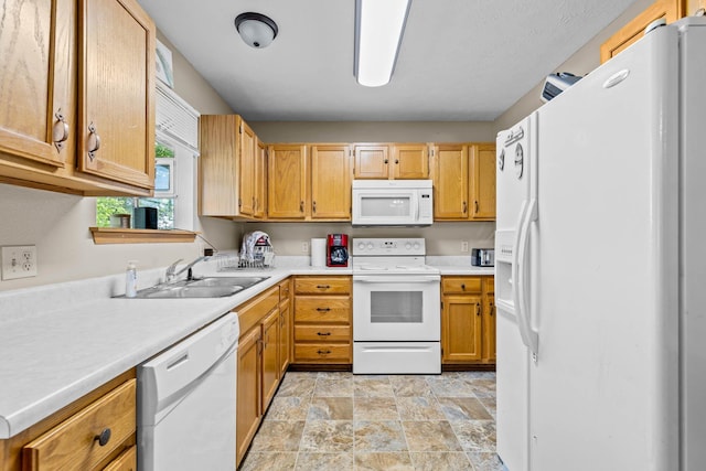 kitchen featuring white appliances and sink