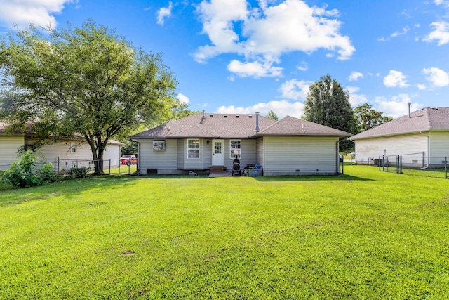 rear view of property featuring a yard