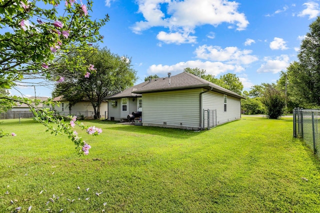 rear view of house with a lawn