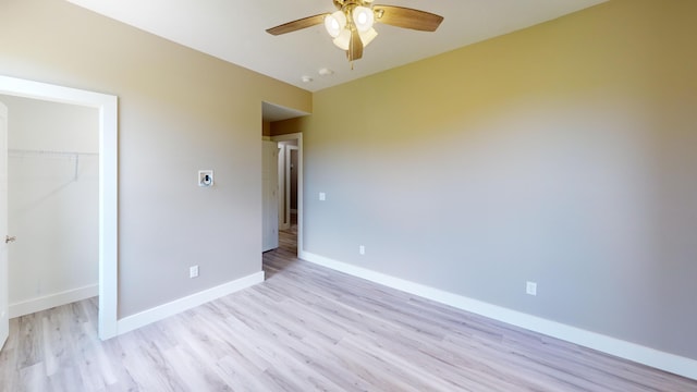 500 Timber Wolf Rd, Hollister, MO 65672 - unfurnished bedroom with light wood finished floors, a closet, a ceiling fan, and baseboards
