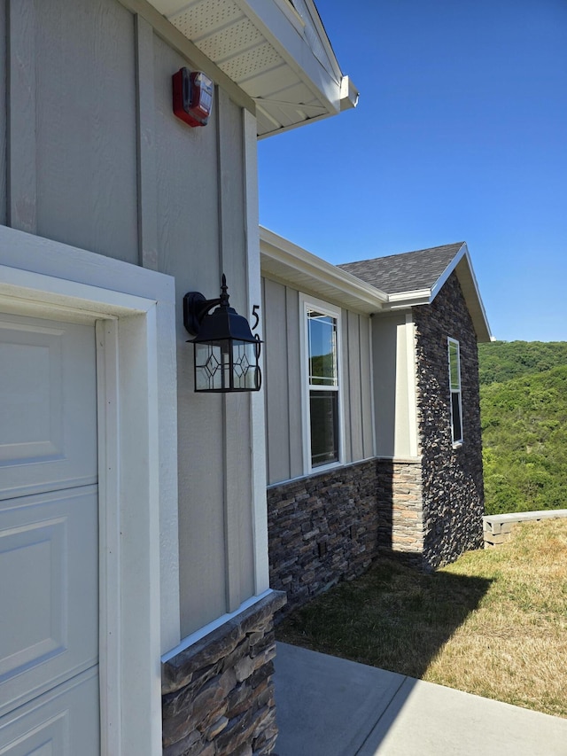 500 Timber Wolf Rd, Hollister, MO 65672 - view of exterior entry featuring a shingled roof and stone siding