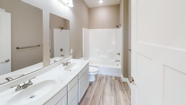 500 Timber Wolf Rd, Hollister, MO 65672 - bathroom with washtub / shower combination, wood finished floors, double vanity, and a sink
