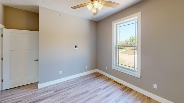 500 Timber Wolf Rd, Hollister, MO 65672 - spare room featuring light wood-style floors, a ceiling fan, visible vents, and baseboards