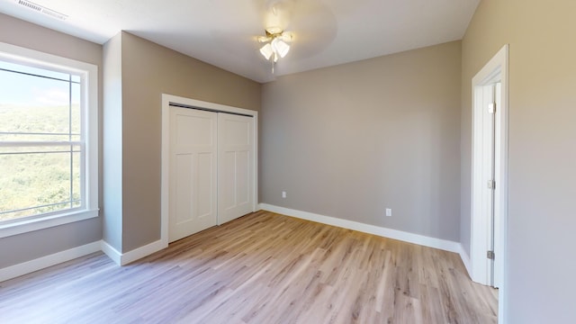 500 Timber Wolf Rd, Hollister, MO 65672 - unfurnished bedroom with baseboards, visible vents, light wood-style floors, and a closet