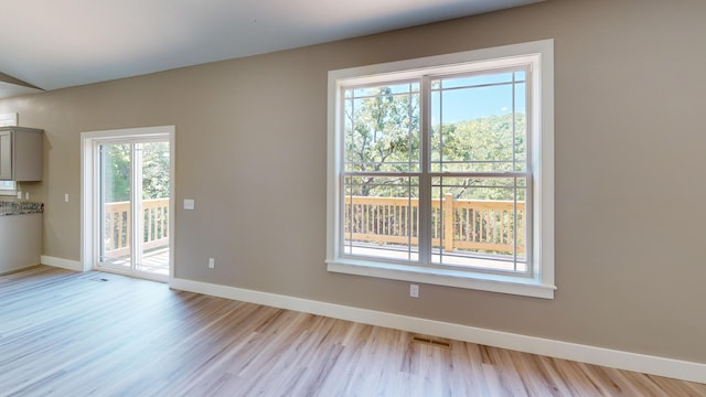 500 Timber Wolf Rd, Hollister, MO 65672 - unfurnished room featuring visible vents, light wood-style floors, and baseboards