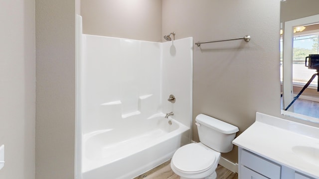 500 Timber Wolf Rd, Hollister, MO 65672 - bathroom with wood finished floors, toilet,  shower combination, and vanity