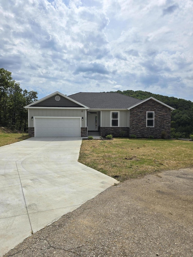 500 Timber Wolf Rd, Hollister, MO 65672 - ranch-style home with driveway, board and batten siding, stone siding, a front lawn, and a garage