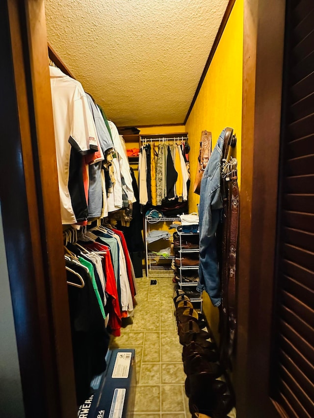 walk in closet with light tile patterned flooring