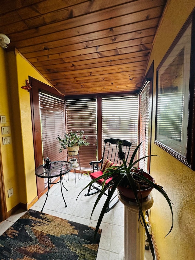 sunroom featuring vaulted ceiling and wooden ceiling