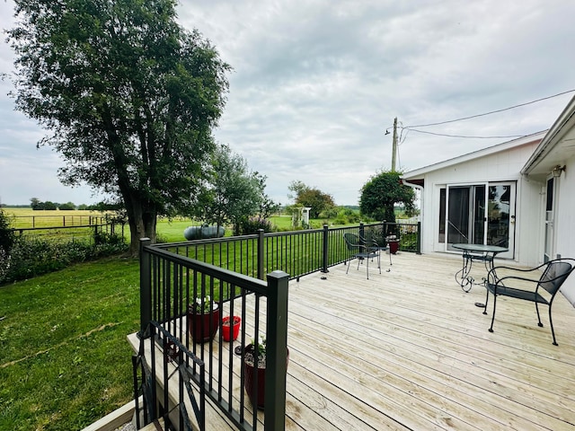 wooden deck featuring a yard