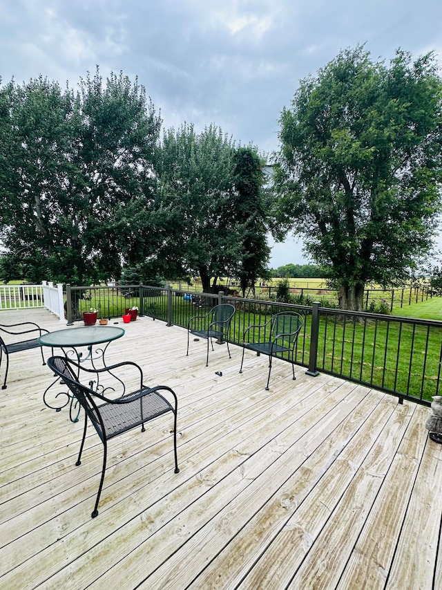 wooden terrace featuring a yard