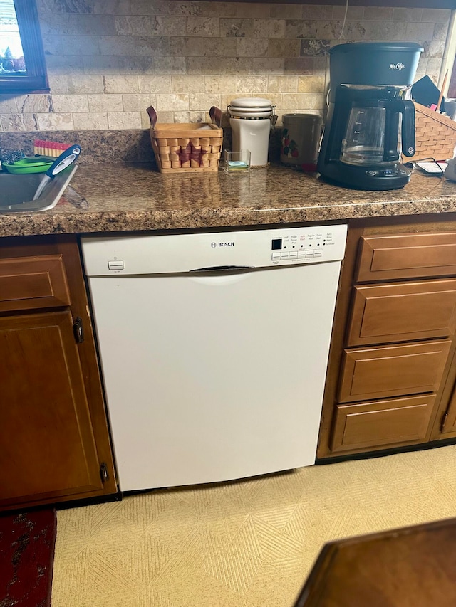 kitchen featuring dark brown cabinets and white dishwasher