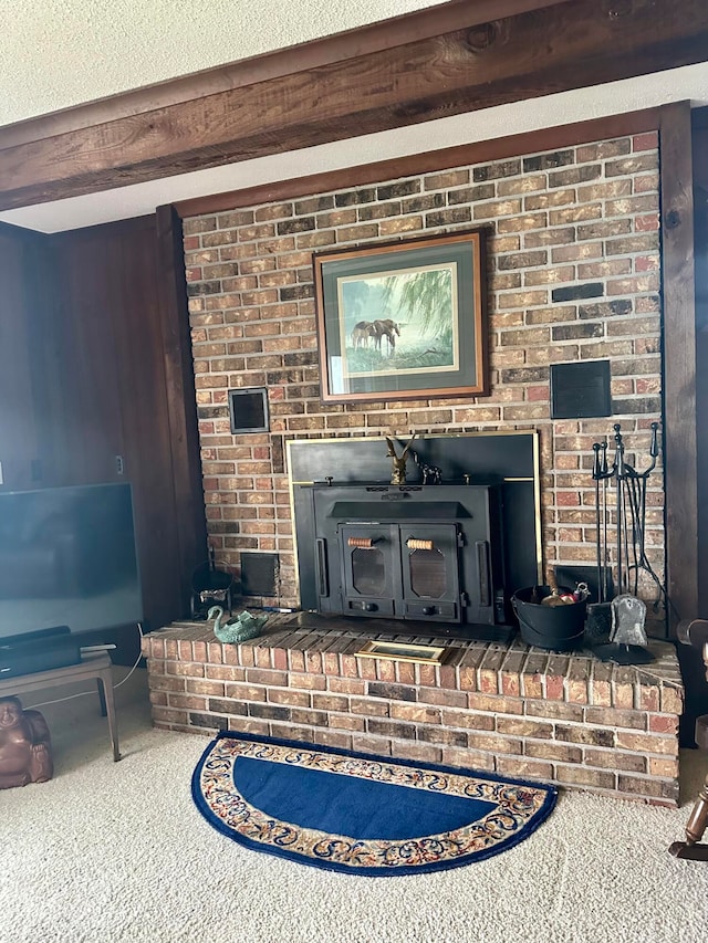 details with a wood stove, beam ceiling, a textured ceiling, and carpet flooring