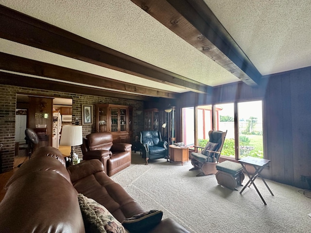 carpeted living room with a wall unit AC, beam ceiling, wooden walls, and a textured ceiling