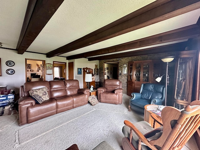 carpeted living room with beamed ceiling and a textured ceiling